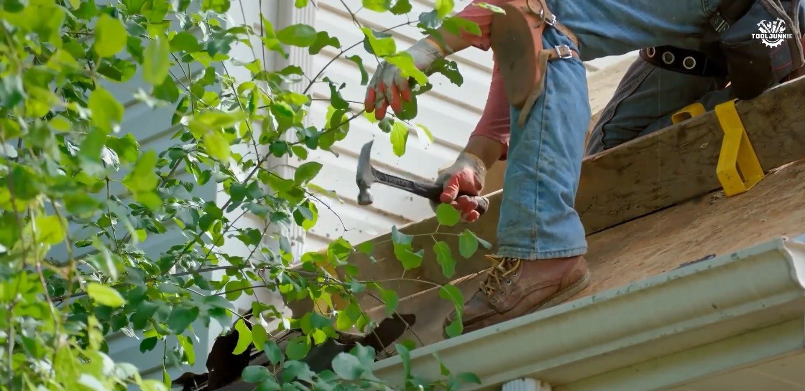 Buffalo Gutter Shield technician cleaning gutters on a Williamsville, NY home